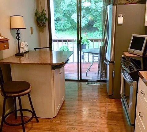 Eat-in kitchen with new stainless steel appliances.