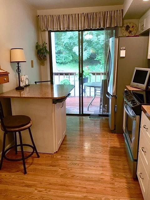 Eat-in kitchen with new stainless steel appliances.