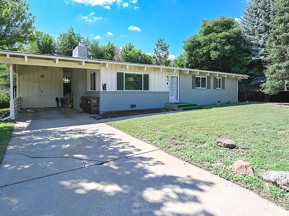 Carport, driveway and sunny front yard