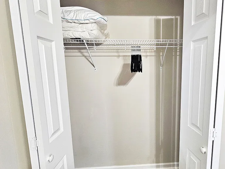 The closet has plenty of space for storage. You will find an extra pillow, blanket, set of linens, and hangers in the closet.