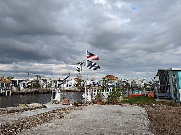 neighbor's flags
Sidewalks and concrete pad running to  seawall
