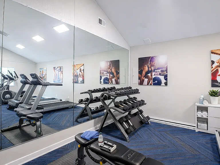 Modern fitness room with equipment and motivators