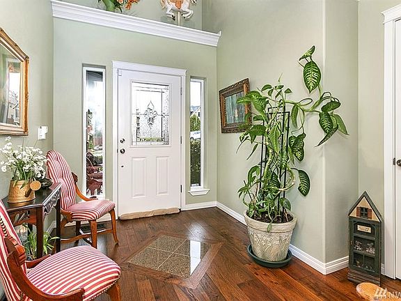 Enter into expansive foyer with granite and hardwood floors.