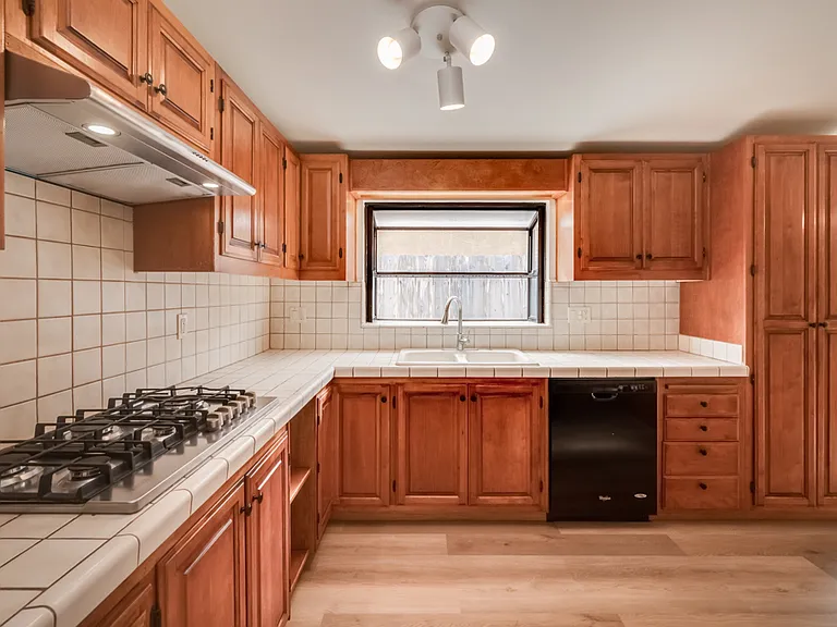 New cooktop, hood, and microwave! Also has dishwasher, refrigerator, and oven. Kitchen has garden window for plants!