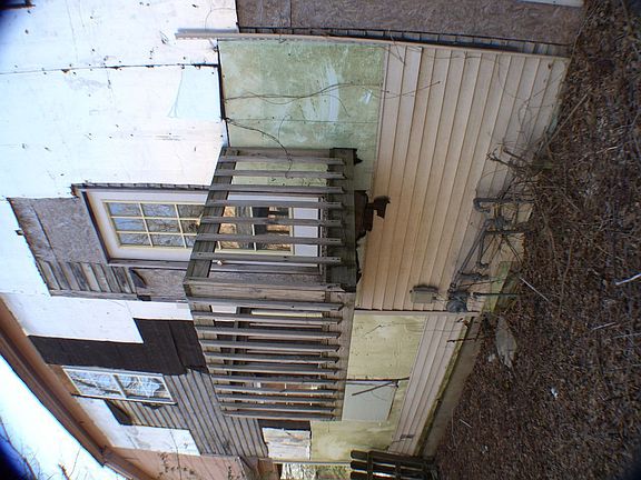 Deck on side of property.  Allows access to both levels of property.