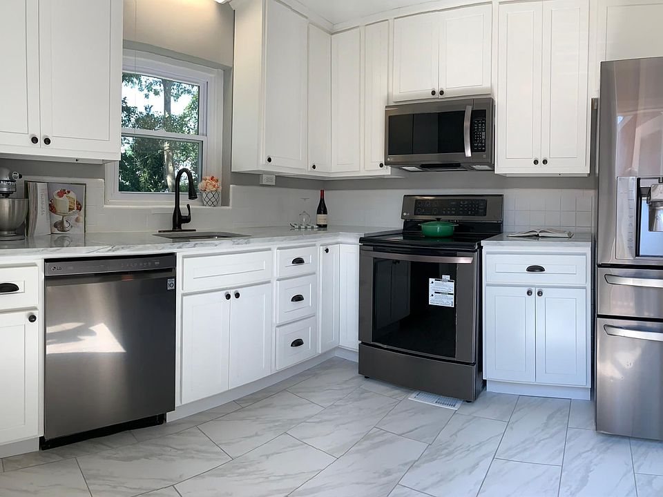 Kitchen updates include new cabinets, countertop, tile floor, and appliances.