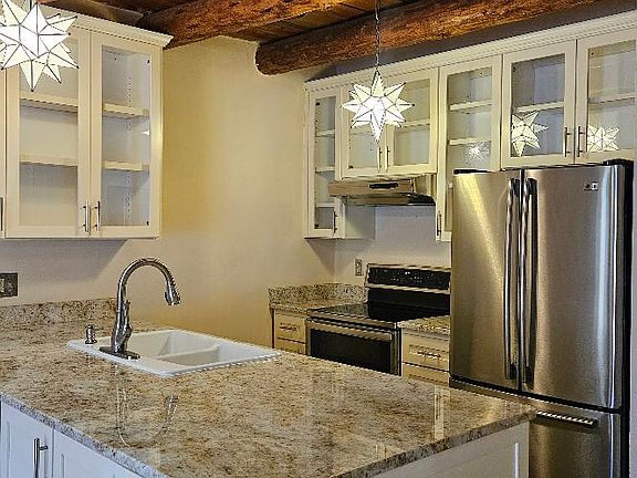 Kitchen with stainless appliances and granite countertops.