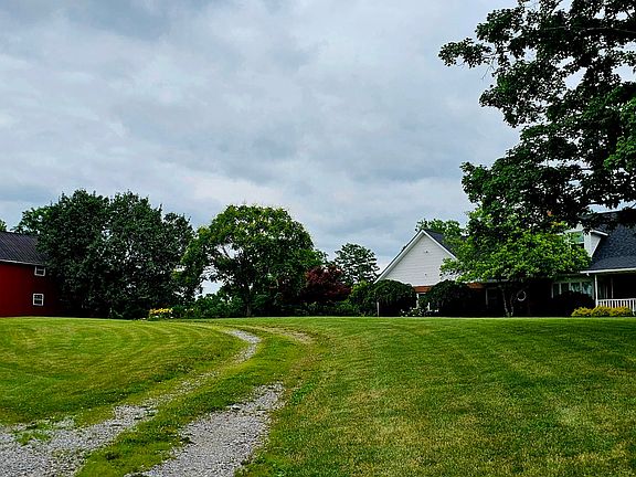 front with drive and barn