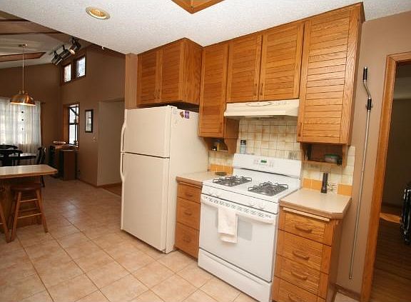 Bright dining area featuring high ceilings and skylights.