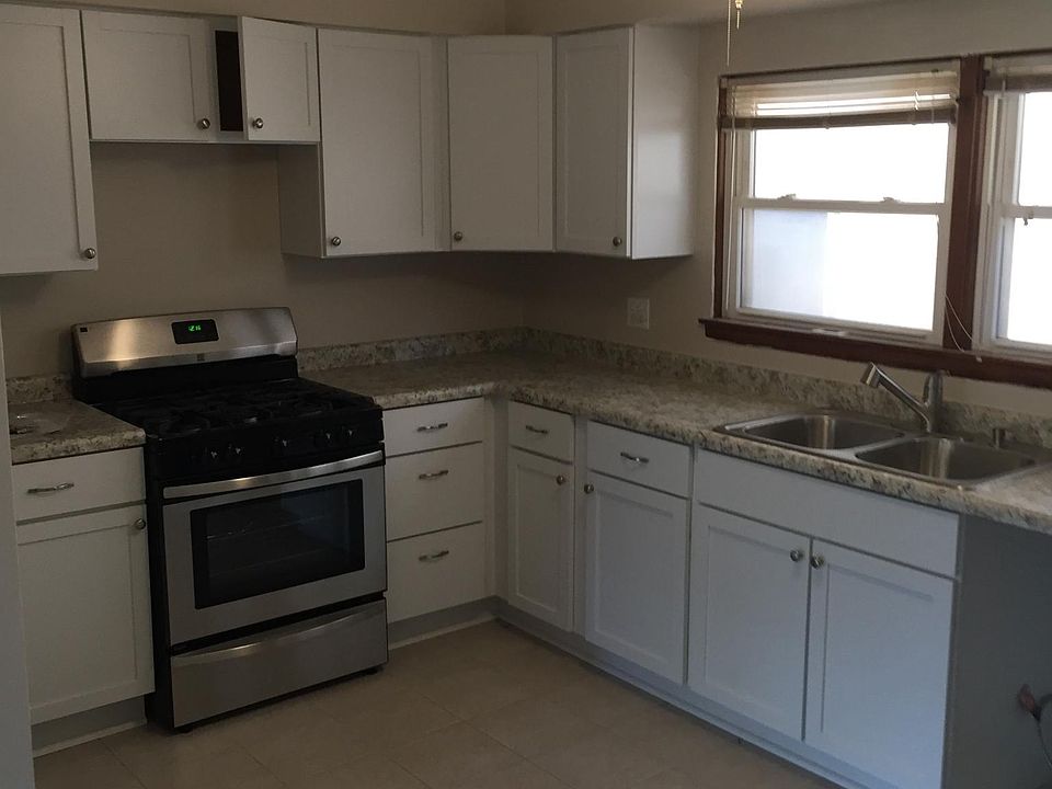 New kitchen awaiting mocrowave above range and dishwasher.