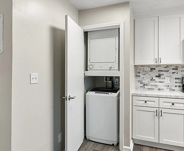 Embrace convenience with this chic kitchen design featuring a built-in laundry nook.