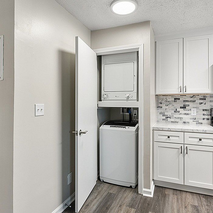 Embrace convenience with this chic kitchen design featuring a built-in laundry nook.