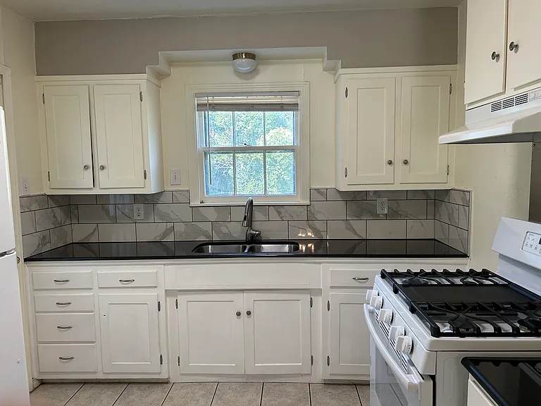 New kitchen counter and backsplash. Refrigerator and gas range included.