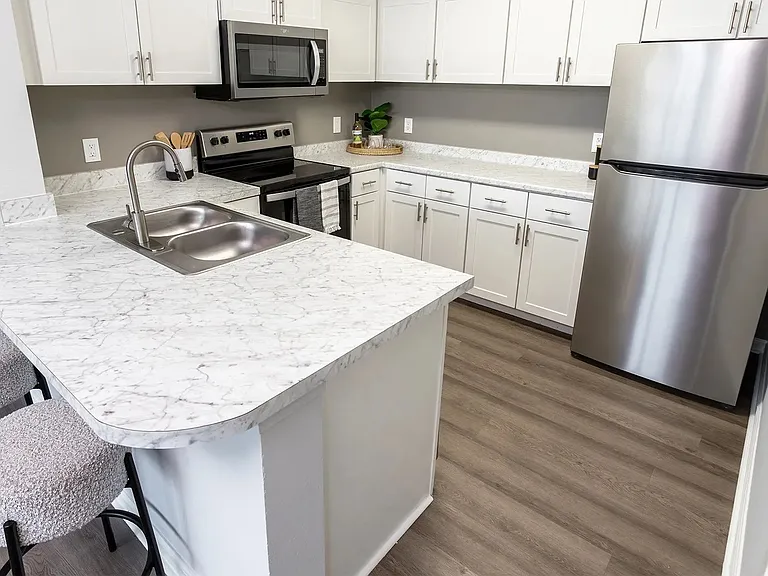 Enter a sleek kitchen oasis, boasting expansive countertop space, polished stainless-steel appliances, and abundant cabinetry. This space seamlessly merges elegance with the practicality you dream of in your ideal home - including a breakfast bar!