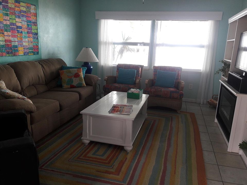 Living room with large flat screen TV and electric fireplace