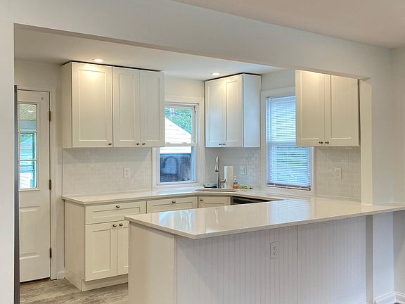 Open / modern living with large kitchen overlooking living room and 3-season patio. New shaker white cabinets with soft close, new stainless steel appliances: gas range, french door fridge with water fountain and ice-maker and beautiful quartz counter top