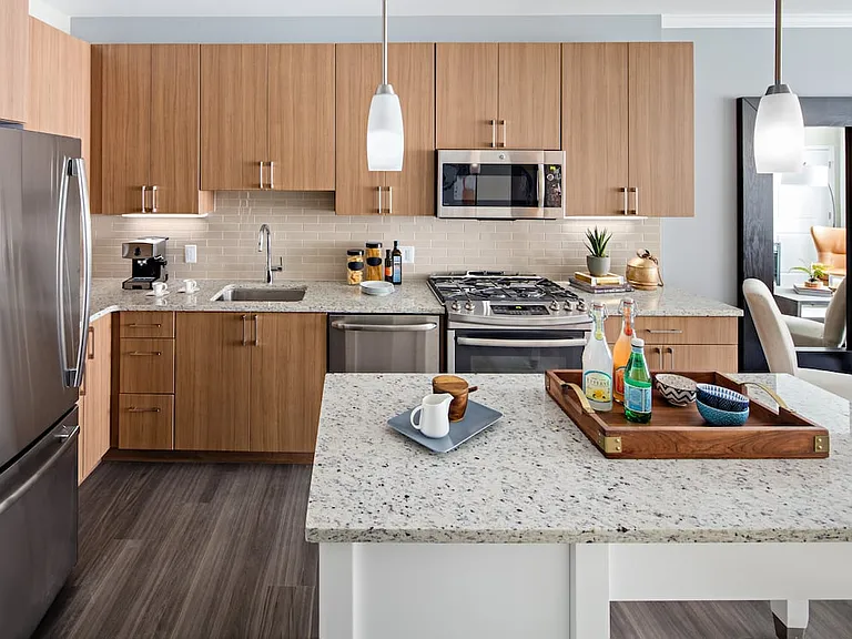 Traditional Collection Kitchen with oak cabinetry, beige tile backsplash, grey granite countertops, stainless steel appliances, and hard surface flooring