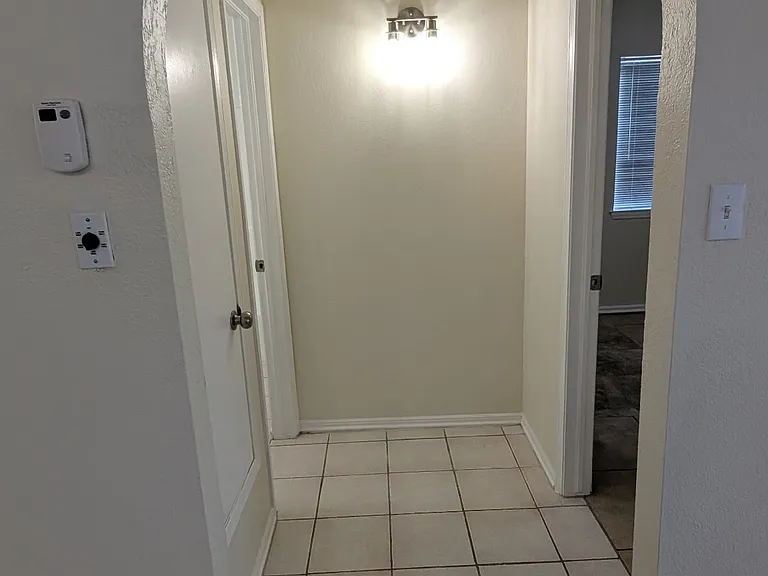 Open doorway leading to the bathroom and main bedroom.