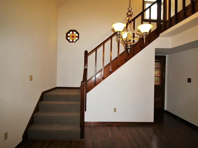 stairs with stain glass window