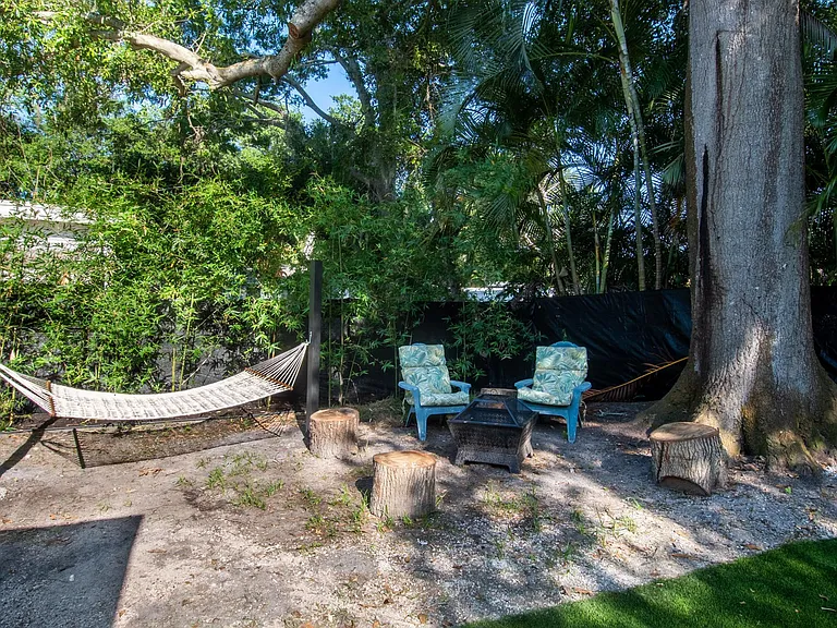 fire pit and hammock under grand oak