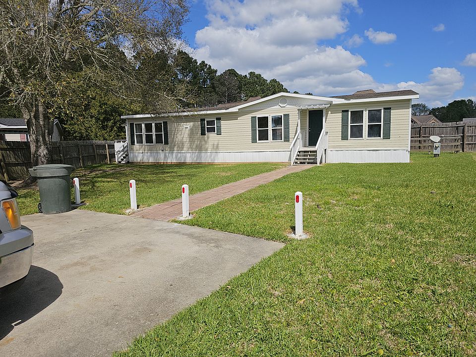 Concrete parking for 2 vehicles off of concrete curb and gutter cul-de-sac. Paver sidewalk to covered front porch.