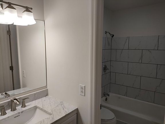 Full bathroom- new vanity and countertop with custom shelving built in for added storage