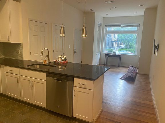 Kitchen has stainless steel appliances and gas stove.