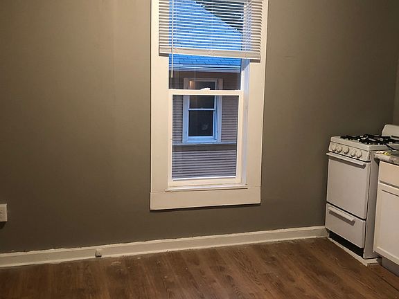 Unit 4 - Efficiency room with hardwood floors, gas stove, pantry/closet area