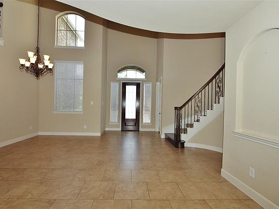 Our first view looking towards the front door shows the lovely arched windows, art niche', tile floors and neutral colors