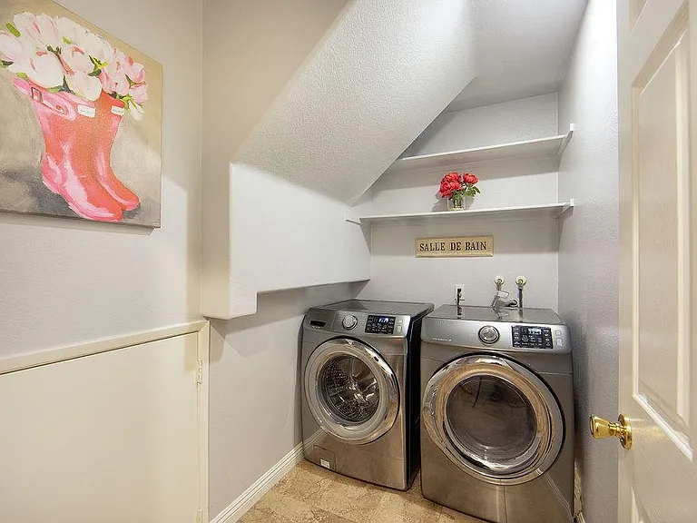 Laundry Room Next to the garage with deep and ample storage on the left side.