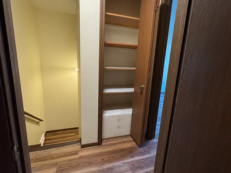 Linen closet in hallway between bedrooms