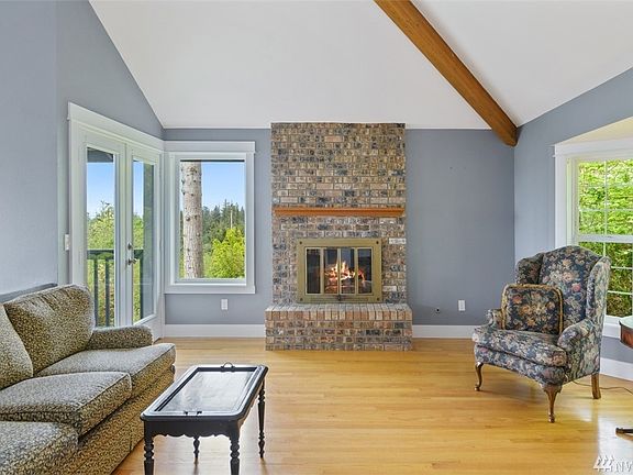 One of the fireplaces located in the living is the best area to sit and enjoy the view.  French doors open to the large cedar decking. 