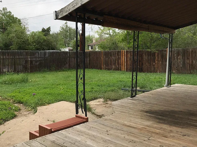 Deck and large fenced in backyard.