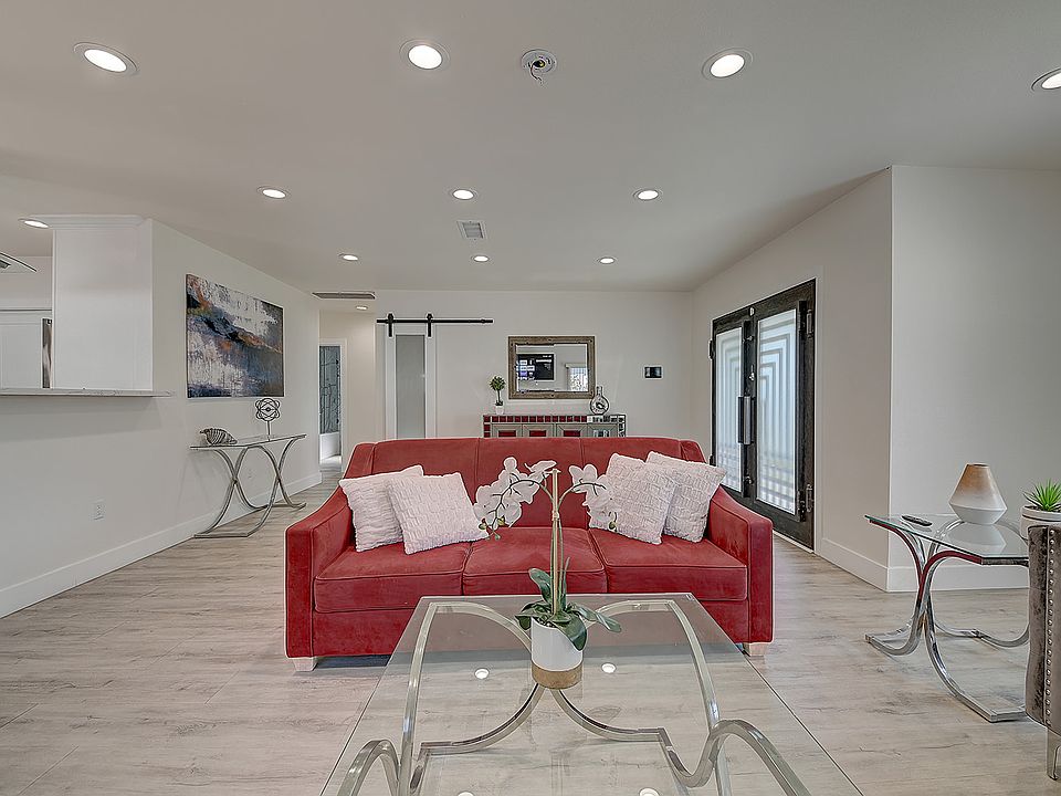 Spacious living area with Smart TV, couch that opens to a queen and sliding door to back yard area.