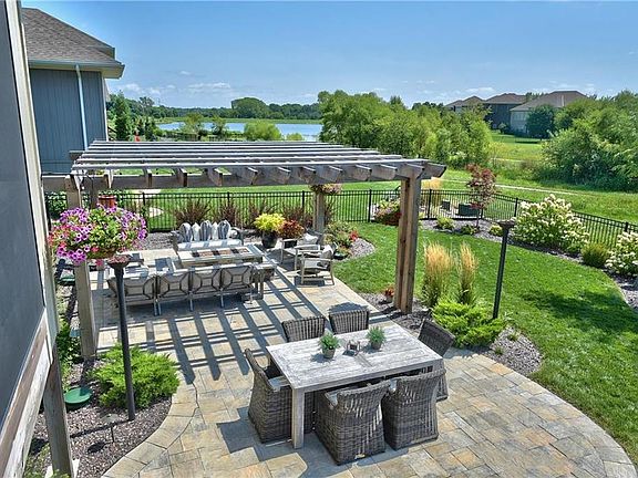 Back patio w/ firepit, pergola, gas torches, lake view