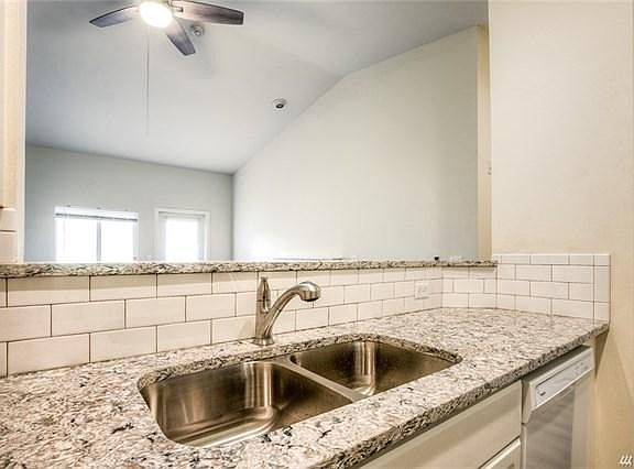 The kitchen looks out to the living room and west facing dec