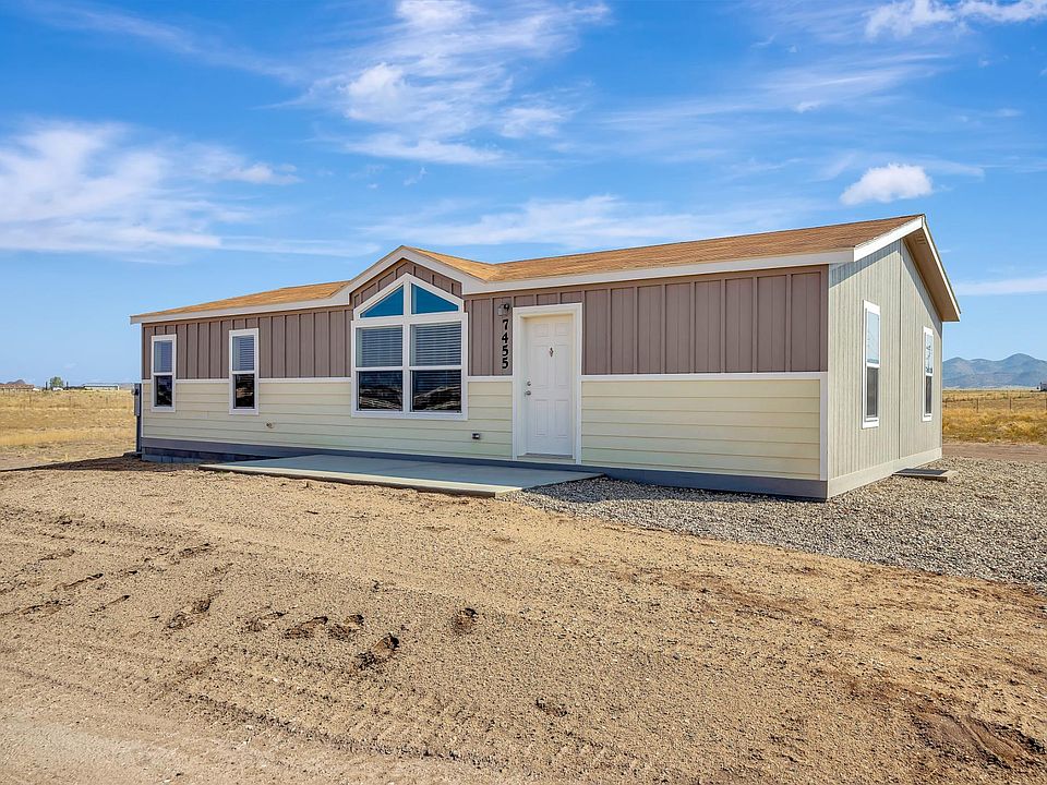 Front view - Nice front concrete patio, 2x6 construction, upgraded siding, trim, insulation, & Low-E vinyl windows & transom windows.  Ground level home with concrete block foundation.