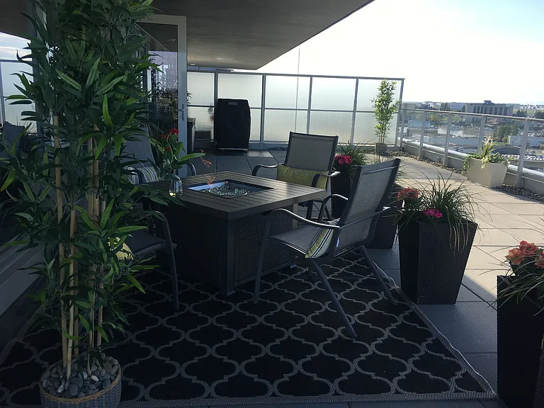 Another view of terrace with fire pit and seating.