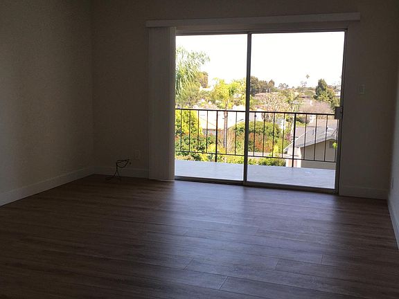 living room with balcony and residential view.