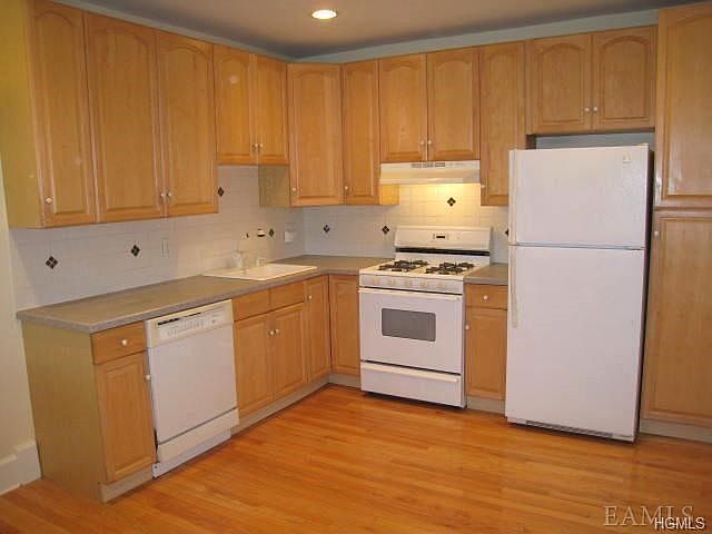 New Kitchen with Corian counters, dishwasher, range and refrigerator.