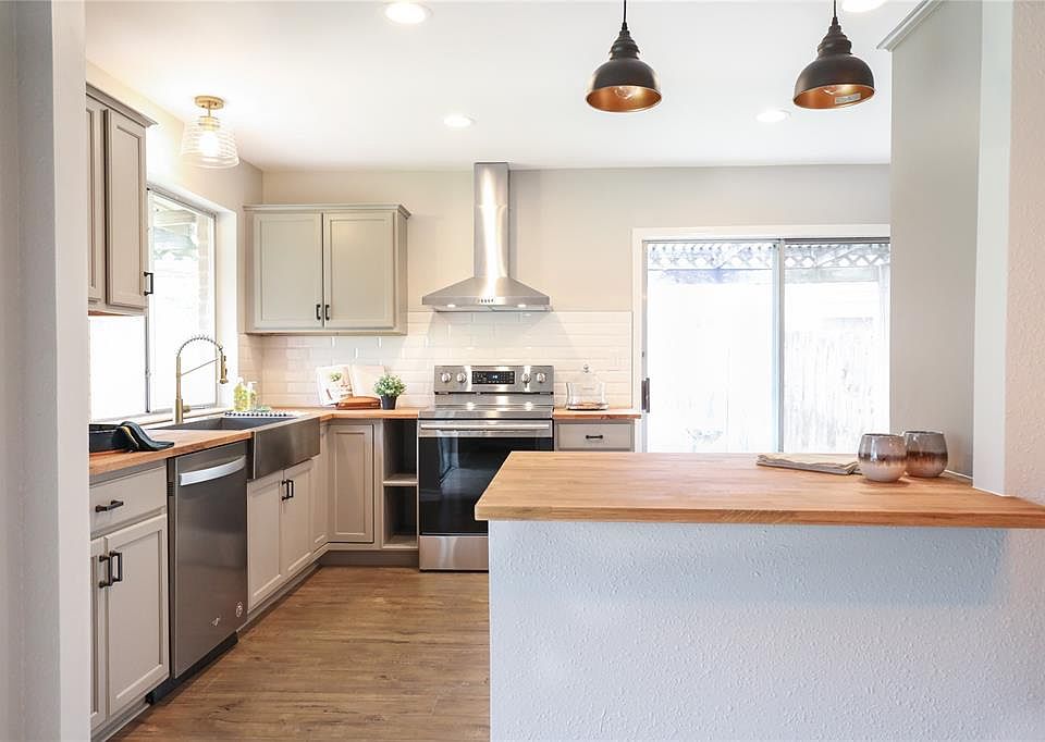 Modern kitchen with all new cabinets, new appliances, new faucet, new vent hood, new counter tops, new light fixtures and new hardware.