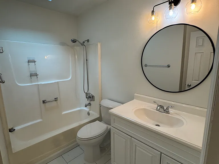 Guest bath refreshed with natural light from skylight and new light fixture.