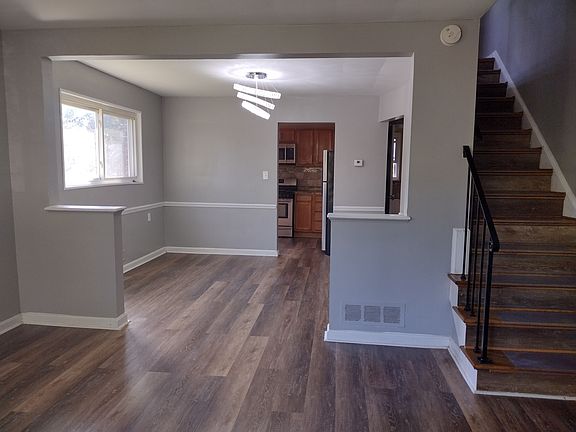 LR/DR w/ Sparkling Retro Chandelier leading to Kitchen