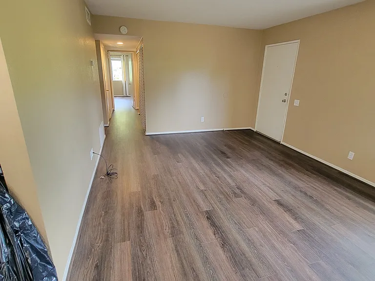 livingroom from front door looking down hall to bedrooms. new flooring