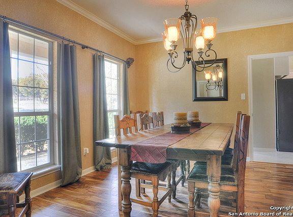 Recent wood flooring & elegant lighting sets the mood for entertaining friends.