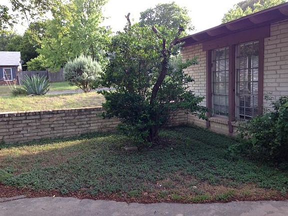 View of side yard, front yard, and street.