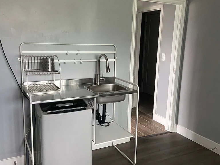Kitchen with washer below sink