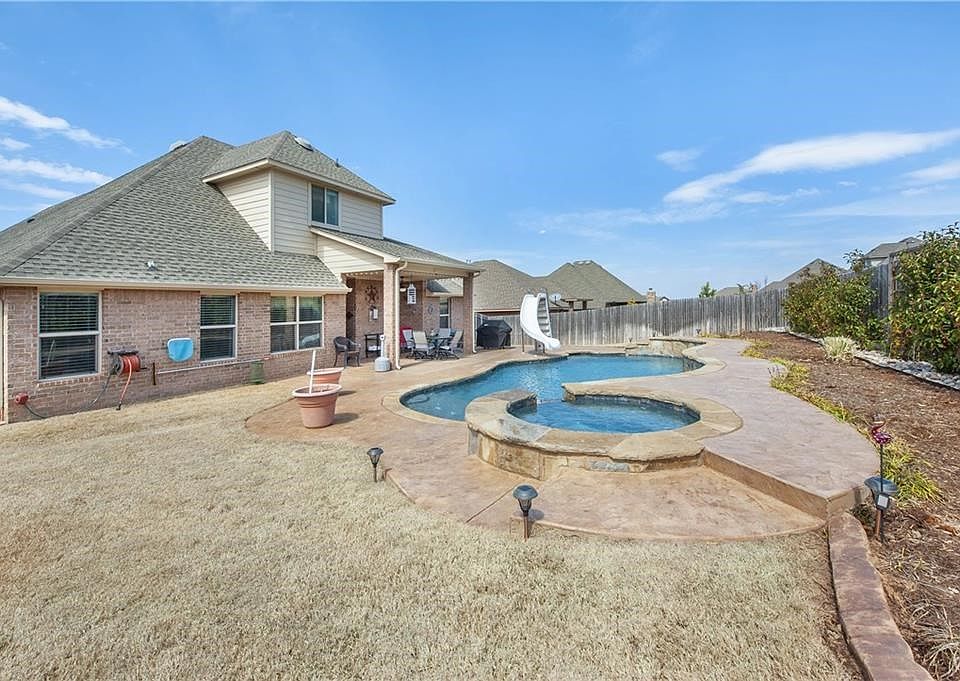 Backyard paradise with hot tub. This family heats the pool for Christmas and has a party out back!