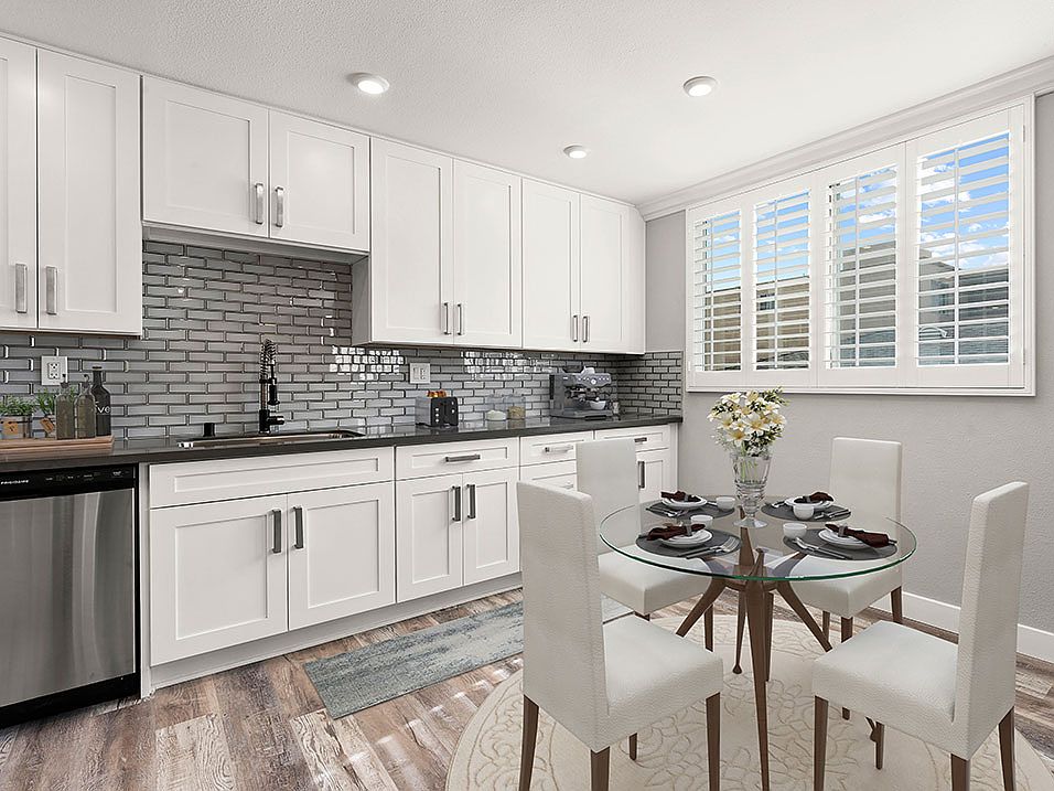 Hardwood floored dining room with view of gorgeous tiled kitchen.