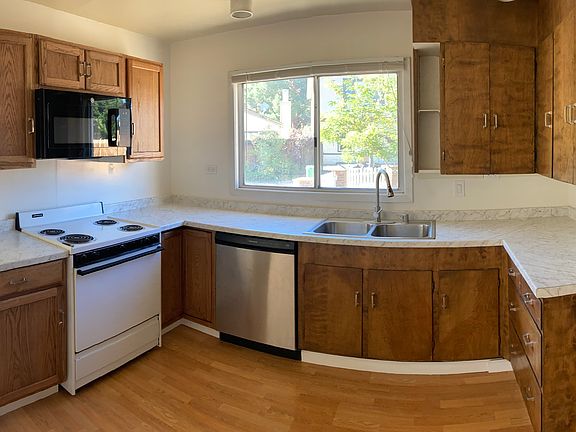 Kitchen with ample storage, range, microwave, and refrigerator with great ice maker.